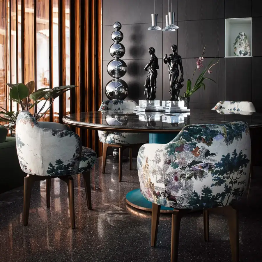 Superior Giorgetti Elisa armchair upholstered in multi-colored cream, green, and brown fabric with walnut Canaletto swivel base