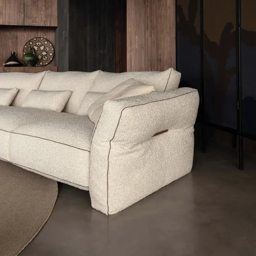 Superior Cierre1972 Loden sofa with inviting low profile, creamy beige bouclé-like textile and elegant leather piping