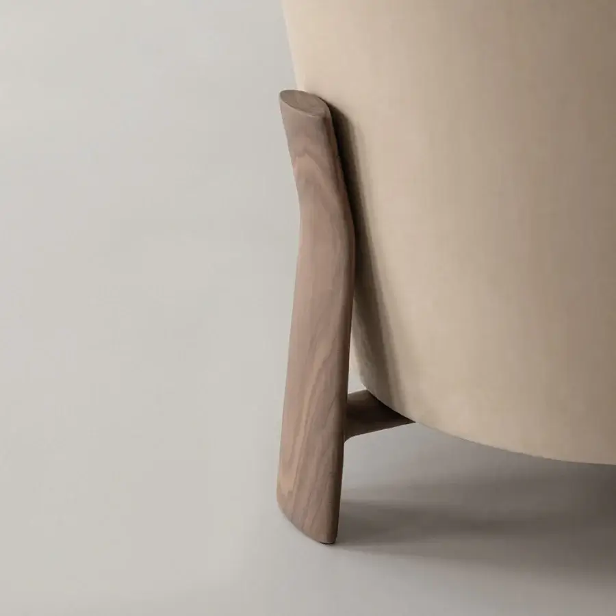 Elegant Cierre1972 Catarina lounge chair in light beige woven textile with a satin-finish sculpted solid walnut frame