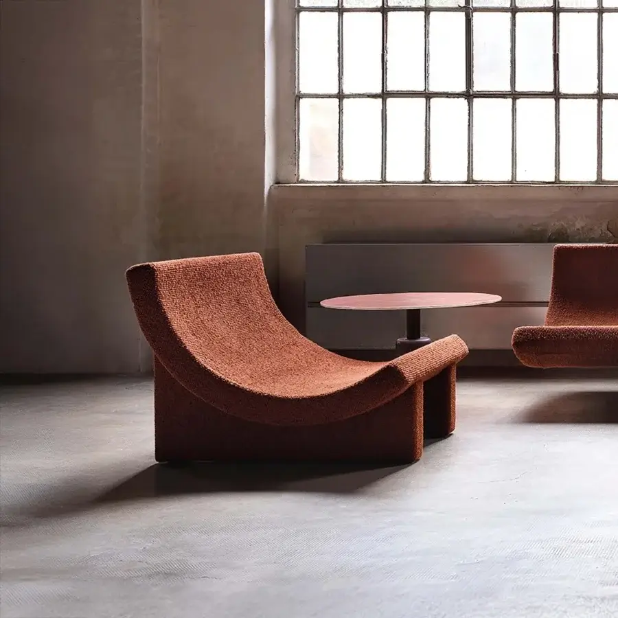 Superior Acerbis Trench lounge chair in textured terracotta upholstery with a sculpted, seemingly suspended form