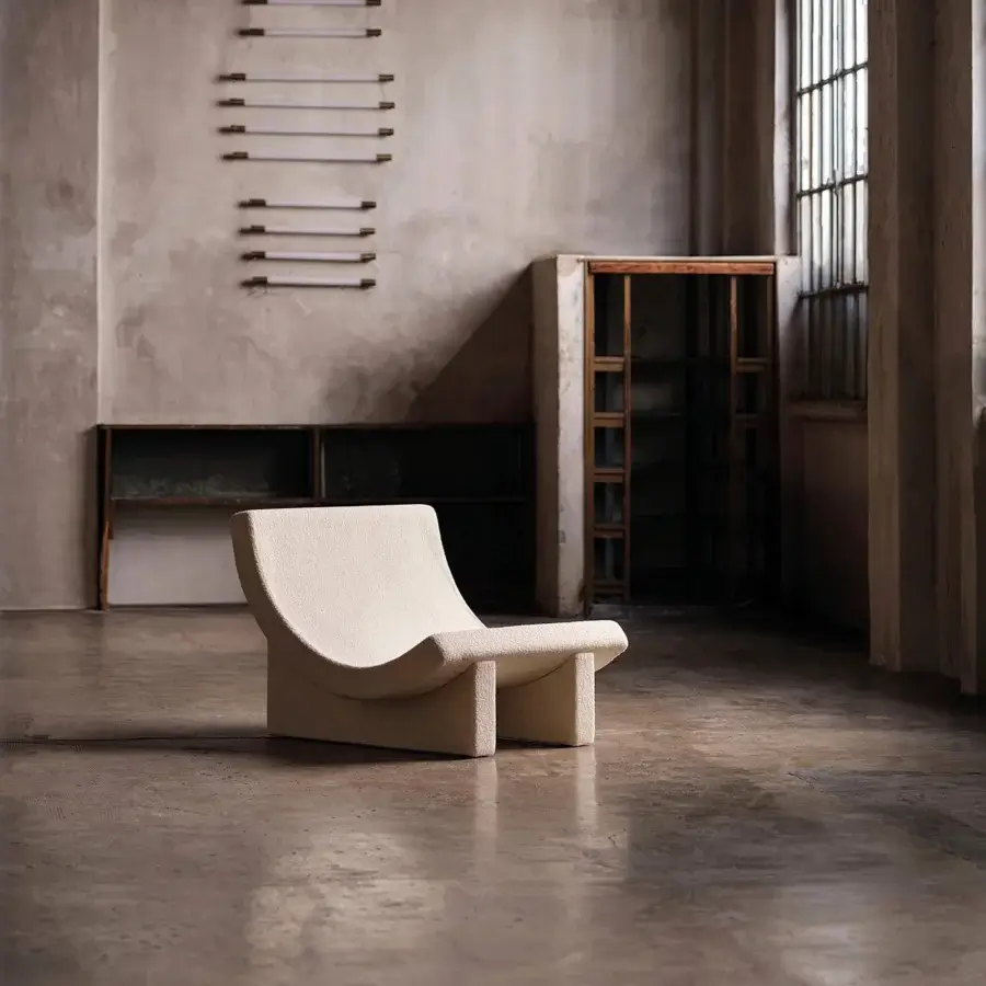 Elegant Acerbis Trench lounge chair in creamy beige textile with seamless integrated armrests and sculpted form