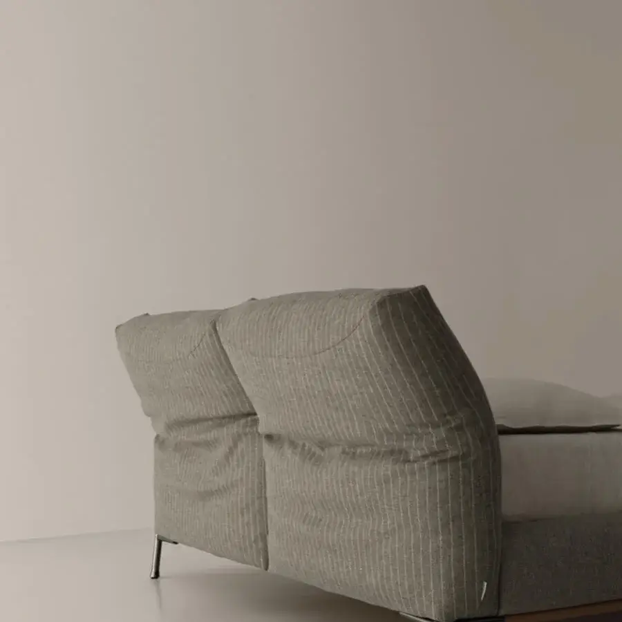 Distinguished Cierre1972 Chapeau Bed built with muted olive green textile and slender cylindrical metal legs with a reclining headboard