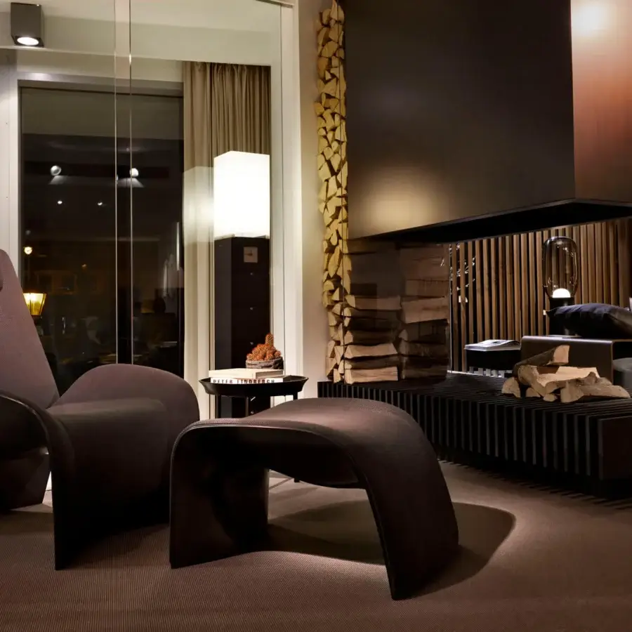 Distinguished Giorgetti Eva lounge chair with a compact rigid polyurethane structure fully upholstered in dark textured textile with a shiny lacquered finish