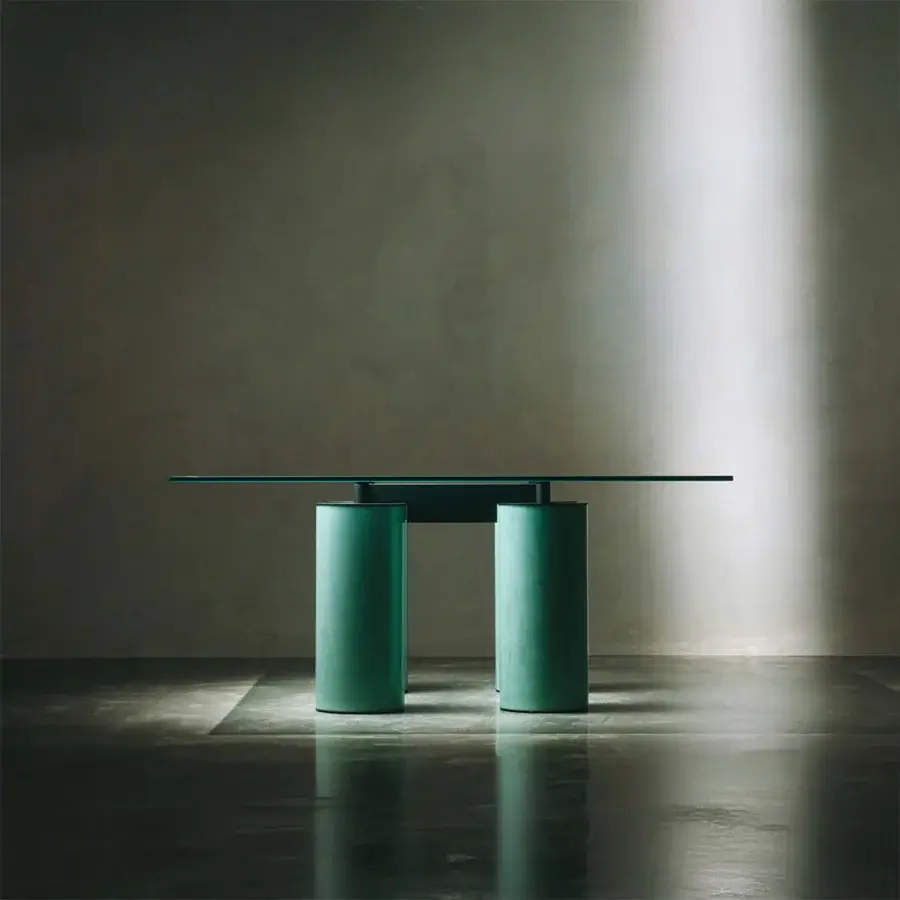 Distinguished Acerbis Serenissimo table with transparent glass tabletop and cylindrical encaustic base in a muted dark teal tone
