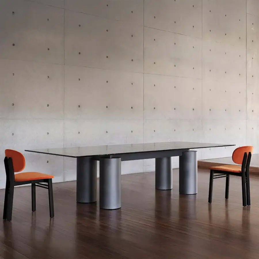 Sophisticated Acerbis Serenissimo table with clear tempered glass tabletop and matte dark gray cylindrical bases crafted in Italy