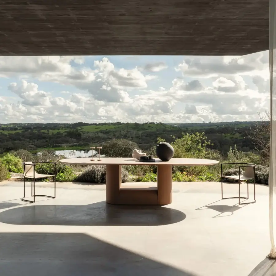Elegant Cierre1972 Samoa table with softly rounded tabletop and cylindrical support in matte terracotta tone