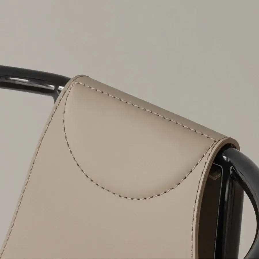 Elegant Cierre1972 Jamiro chair crafted in light beige synthetic leather with a glossy black metal frame