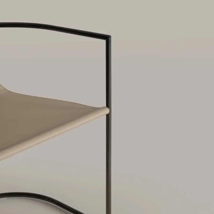 Distinguished Cierre1972 Jamiro chair built with dark matte metal and light beige textile offering a contemporary aesthetic
