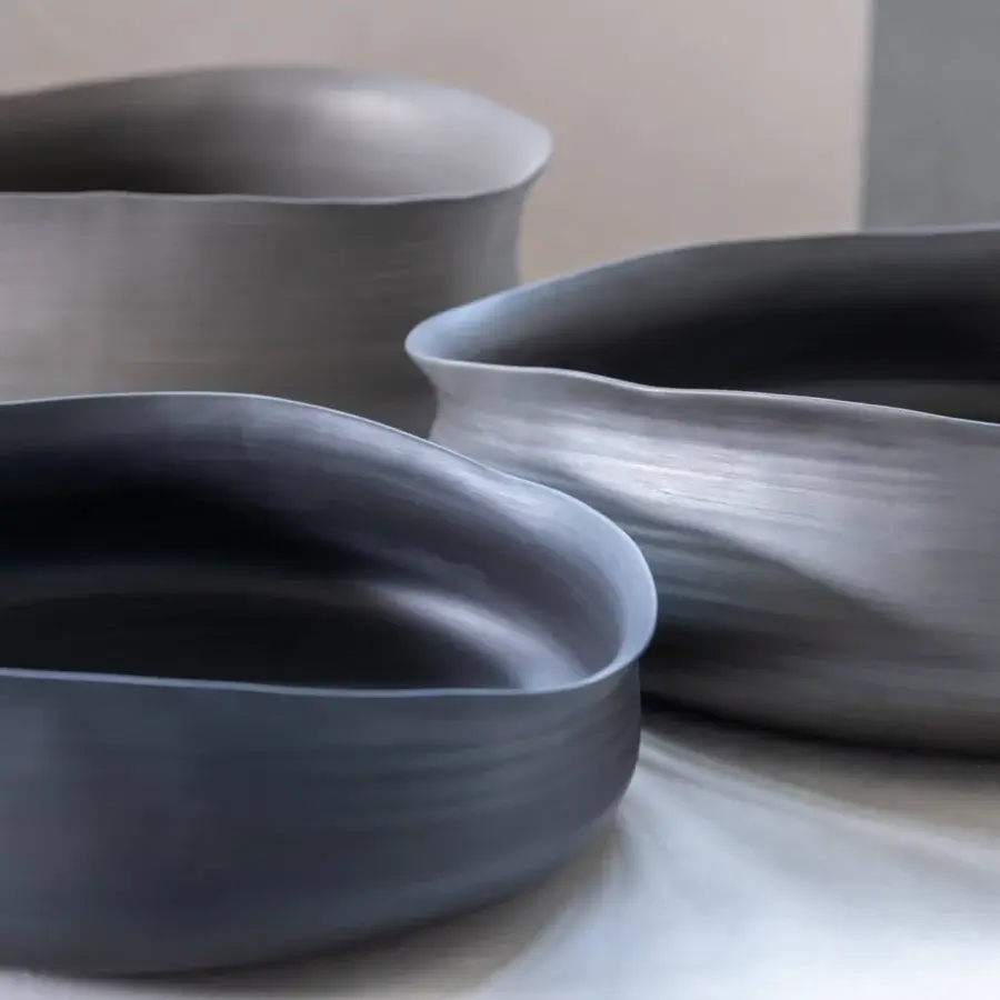Exceptional Rina Menardi Cenote vessels crafted from baked clay with a matte textured finish in dark gray tones