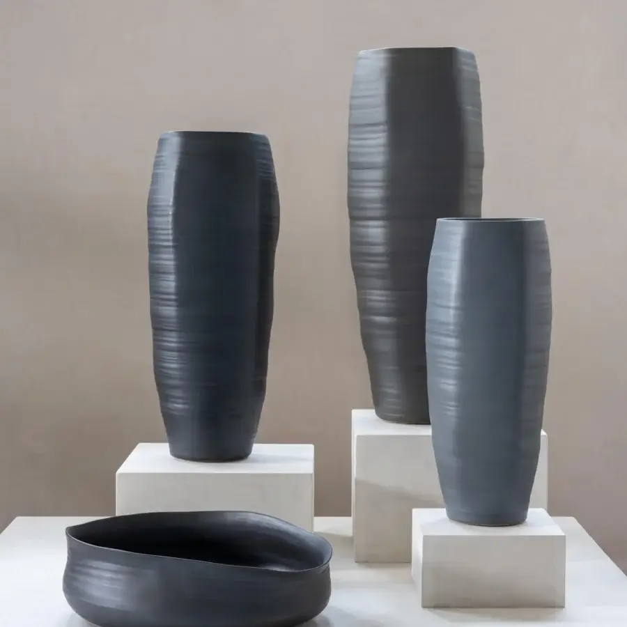 Distinguished Rina Menardi Cenote vessel set crafted in baked clay with light stone bases and matte dark gray finish