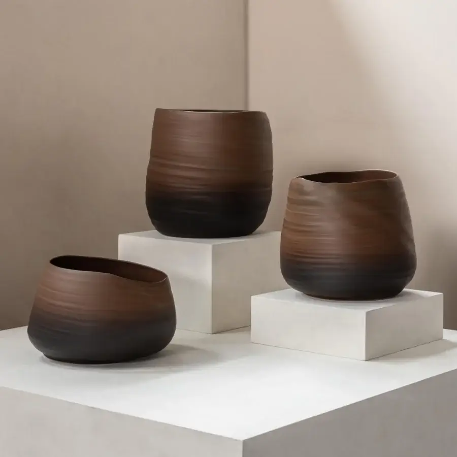 Luxury Rina Menardi Cenote Alto vessel crafted from baked clay in dark brown with a subtly textured, ridged surface