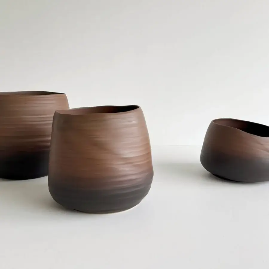 Distinguished Rina Menardi Cenote Alto vessel sculpted from baked clay with warm to dark brown gradient and subtly striated matte finish