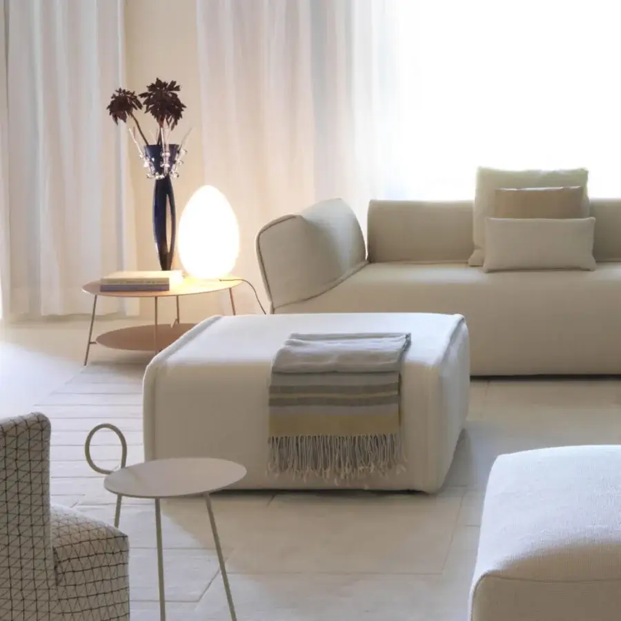 Distinguished FontanaArte Uovo table lamp crafted in white satin blown glass with a matte finish and white painted metal base