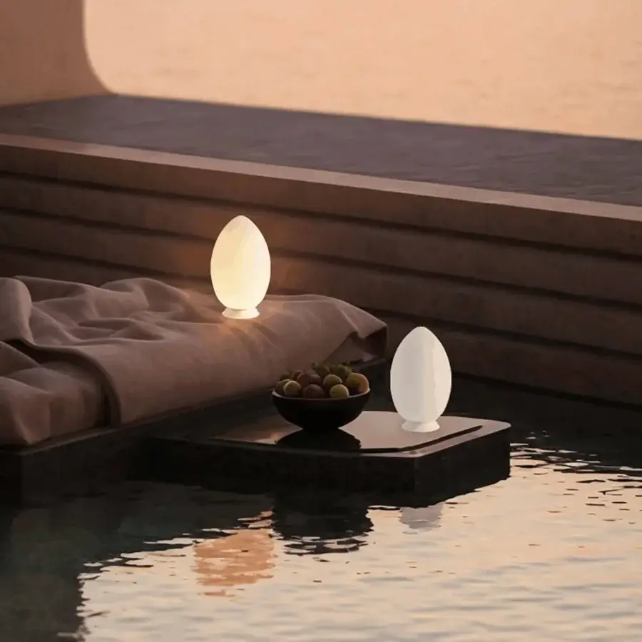 Distinguished FontanaArte Uovo portable lamp crafted in off-white satin blown glass embodying a minimalist aesthetic and timeless design