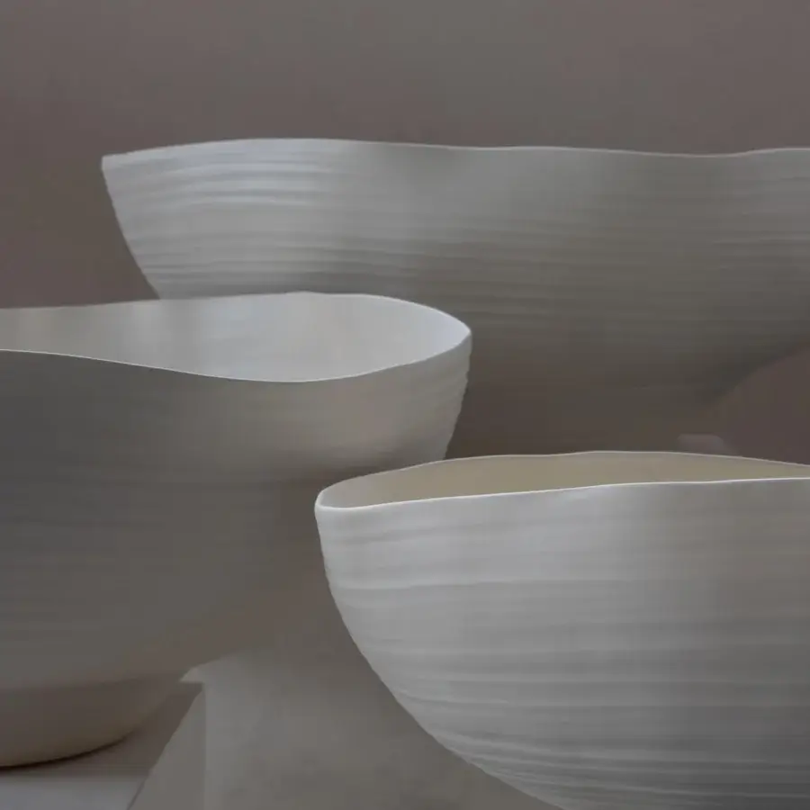 Elegant Rina Menardi Fonti vessel sculpted from baked clay with an organic curved form and pale off-white tone