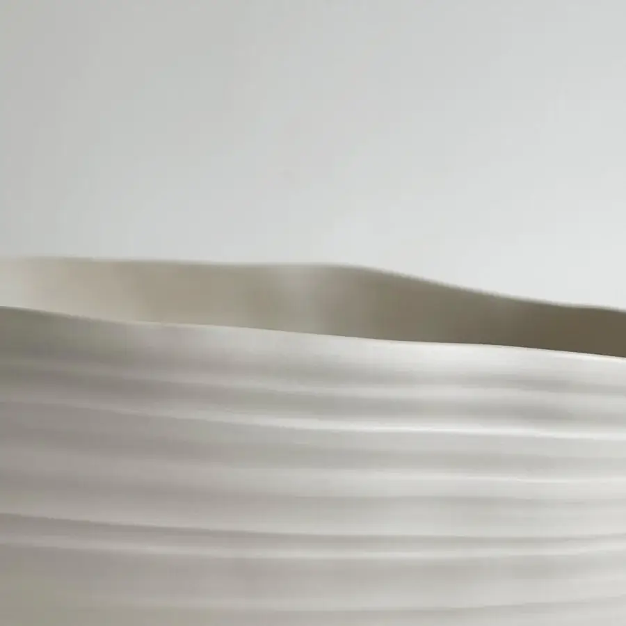 Superior Rina Menardi Fonti vessel crafted from baked clay with an organic undulating form and neutral beige finish