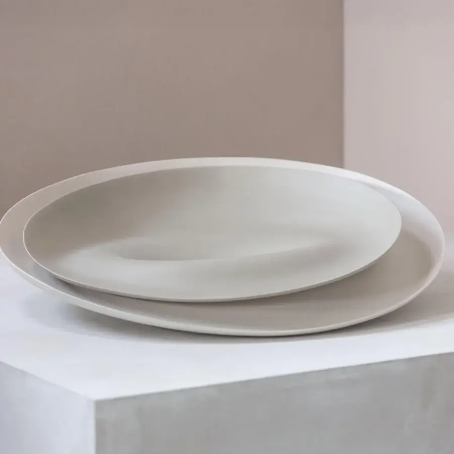 Elegant Rina Menardi Trottole centerpiece crafted in baked clay with a smooth matte pale beige finish