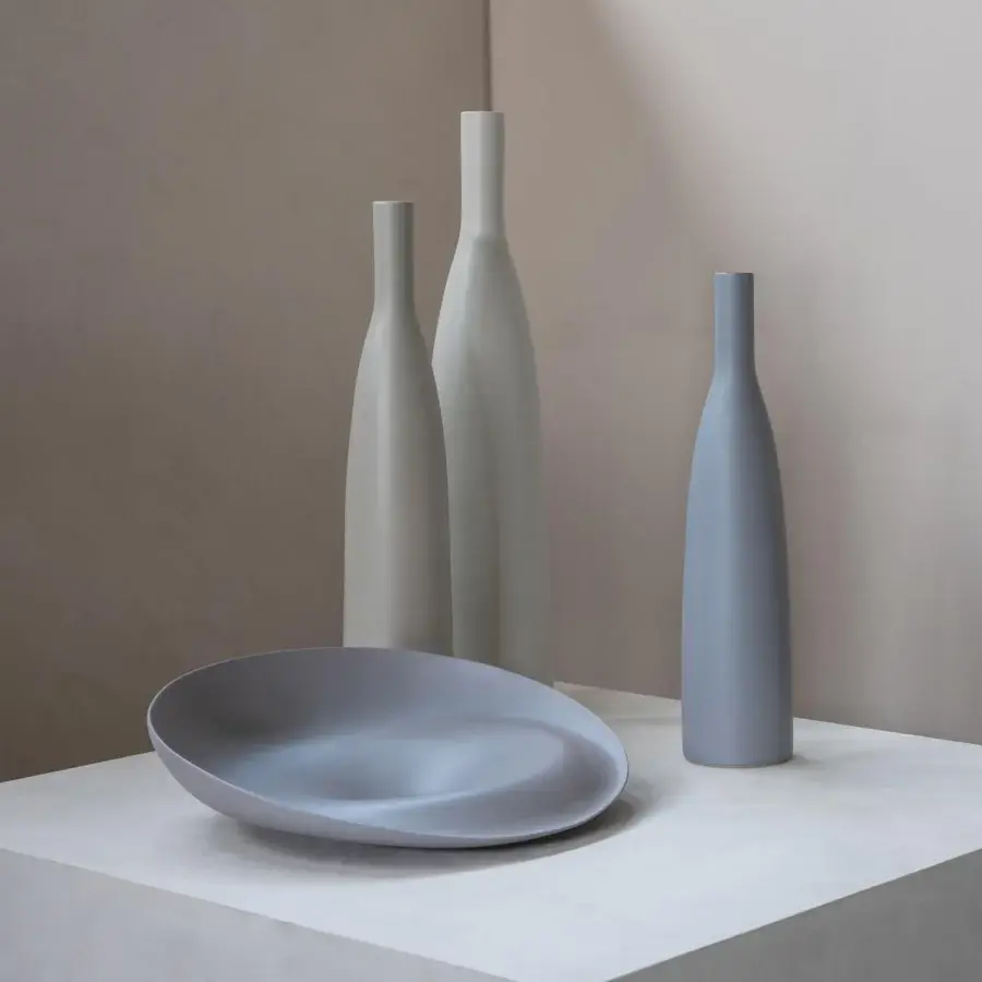 Distinguished Rina Menardi Trottole centerpiece crafted from baked clay with a smooth matte finish and flowing curved lines