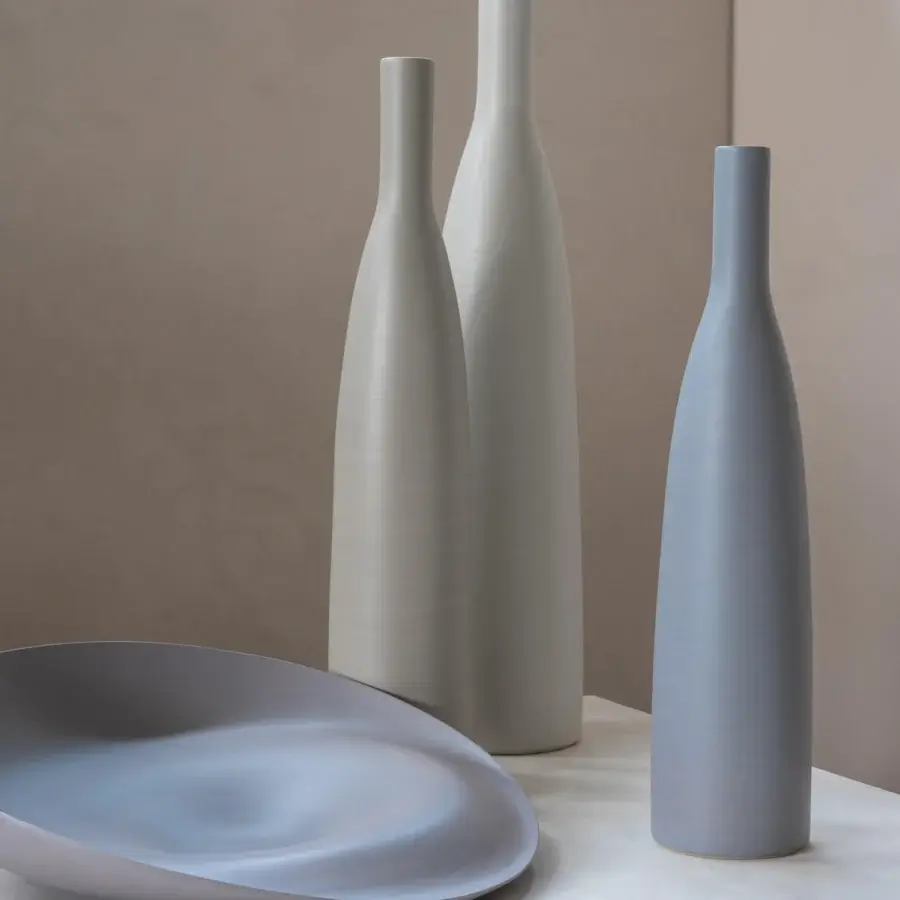 Captivating Rina Menardi Trottole centerpiece crafted from baked clay with a smooth matte finish in pale grey and stone beige
