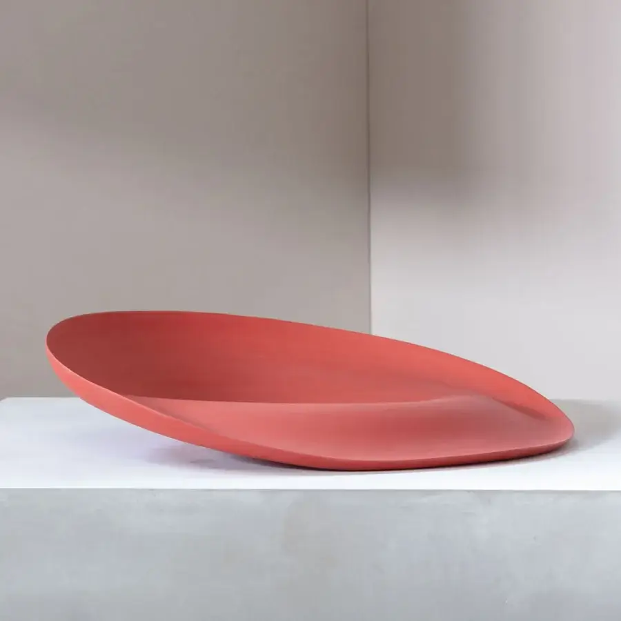 Exclusive Rina Menardi Trottole centerpiece crafted from baked clay with a muted coral-red hue and smooth matte finish