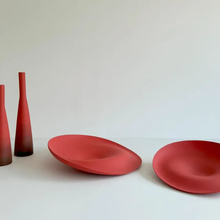 Distinguished Rina Menardi Trottole centerpiece crafted from baked clay in a saturated red with a smooth matte finish