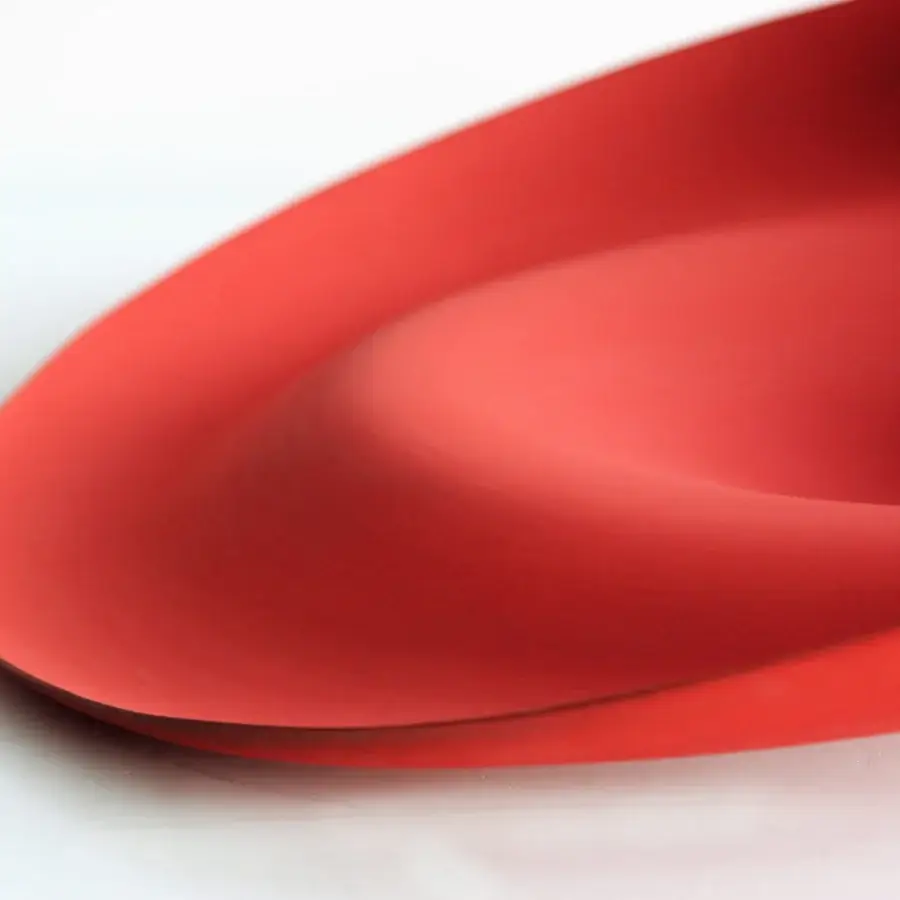 Exclusive Rina Menardi Trottole centerpiece crafted from baked clay with a vibrant red organically curved form and smooth matte finish