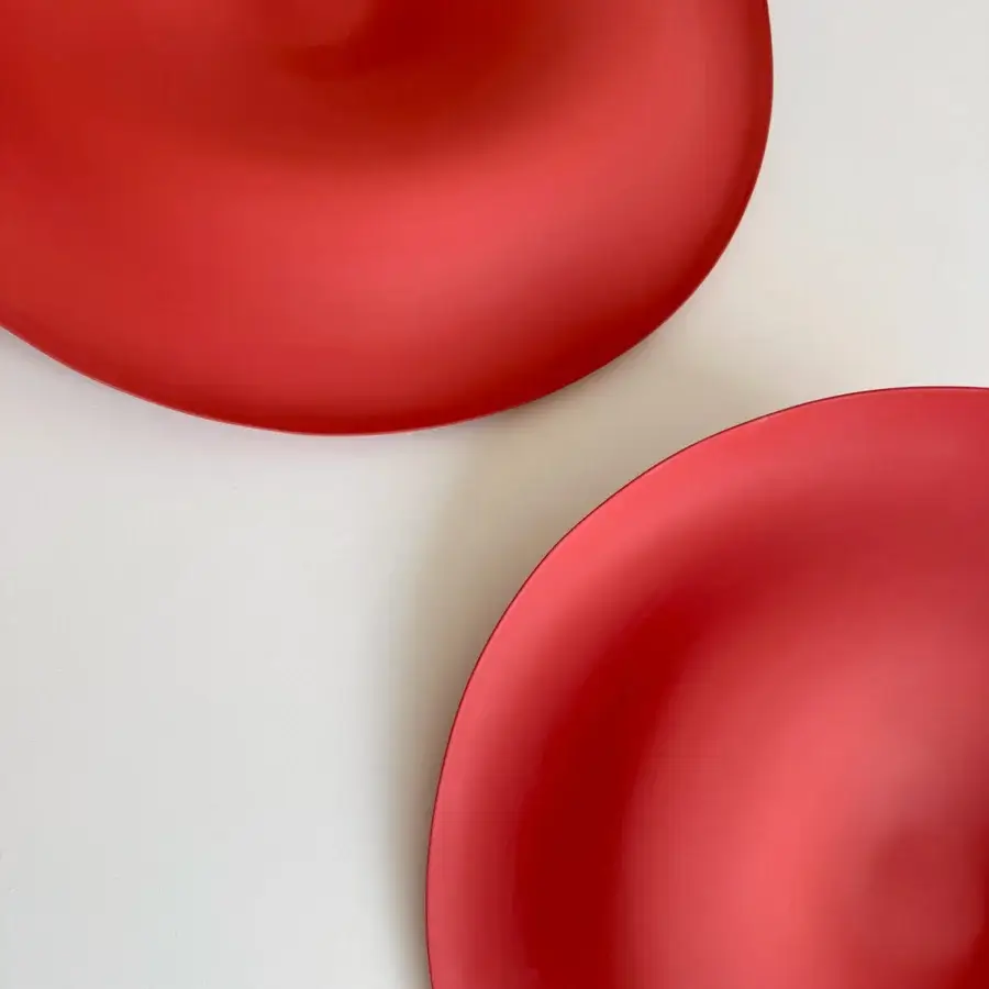 Exceptional Rina Menardi Trottole centerpiece crafted from baked clay in vibrant red with a matte finish