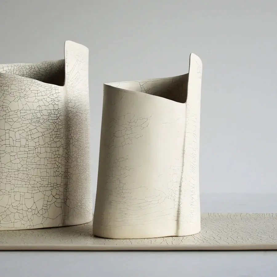 Exceptional Rina Menardi Torri vase crafted from baked clay with a uniquely cracked matte finish in an off-white tone