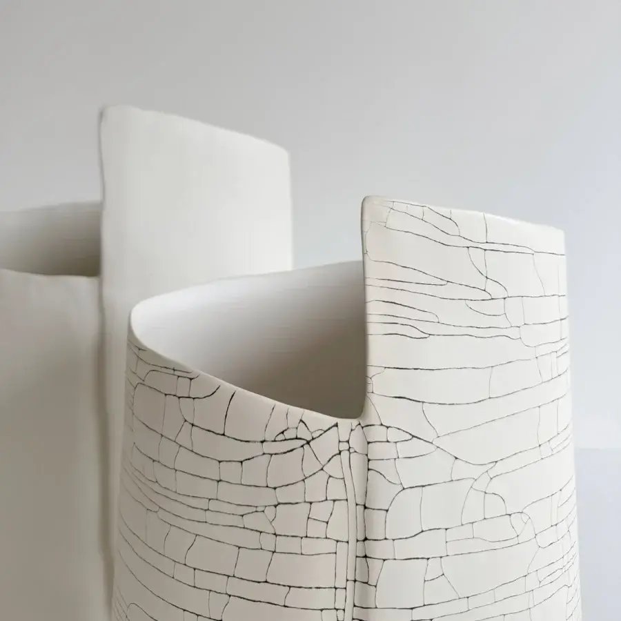 Exclusive Rina Menardi Torri vase sculpted from baked clay with a cracked stone-like pattern and matte off-white ceramic surface