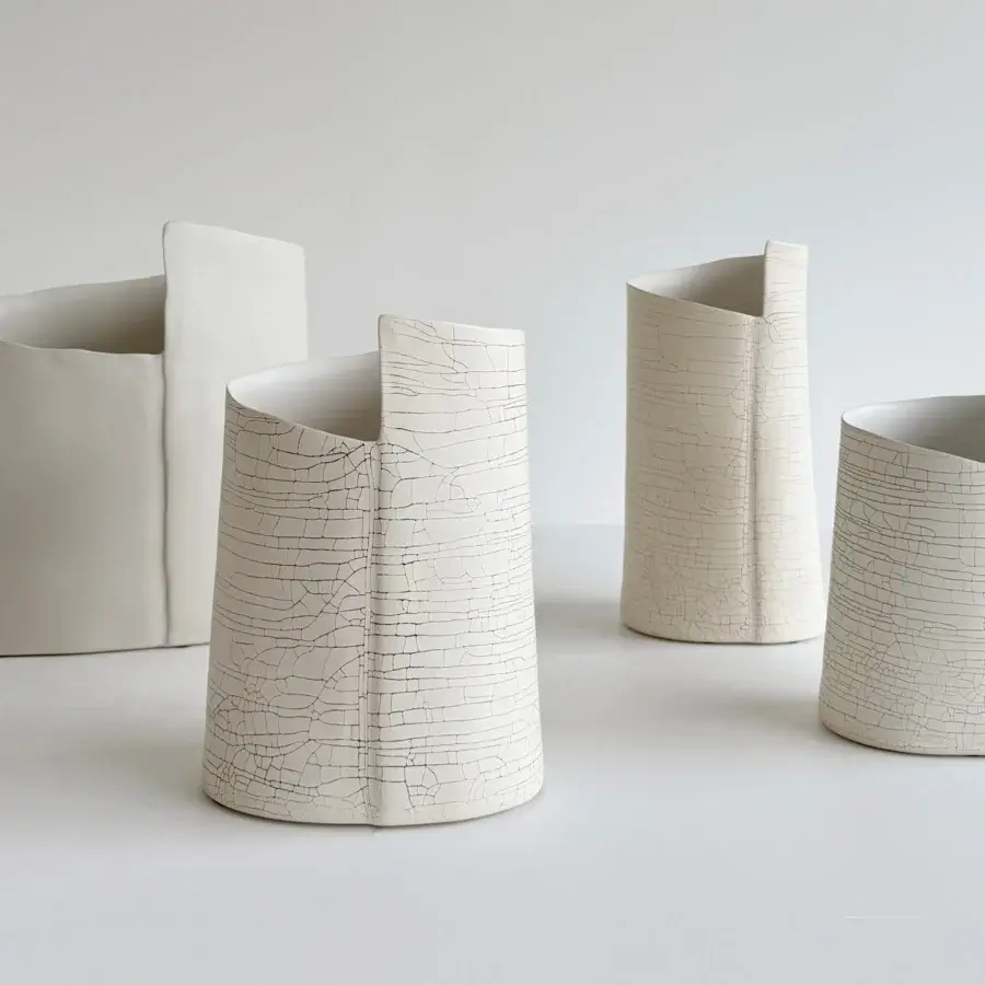 Distinguished Rina Menardi Torri vase sculpted from baked clay with a deliberately cracked, matte off-white surface