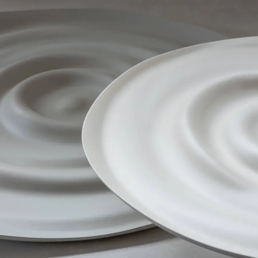Exclusive Rina Menardi Vortici centerpiece crafted in baked clay with a swirling organic pattern and smooth matte finish