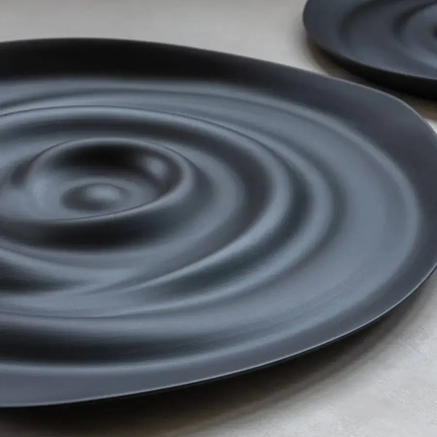 Exceptional Rina Menardi Vortici centerpiece crafted in dark gray baked clay with swirling wave-like design and matte finish