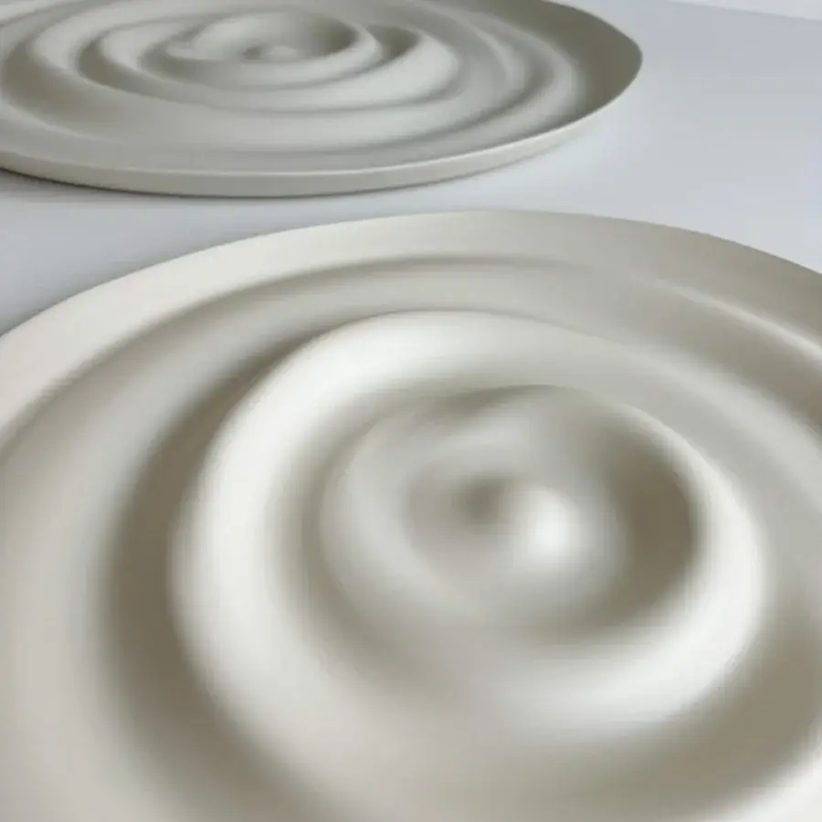 Luxury Rina Menardi Vortici centerpiece crafted in pale beige baked clay with a smooth matte finish