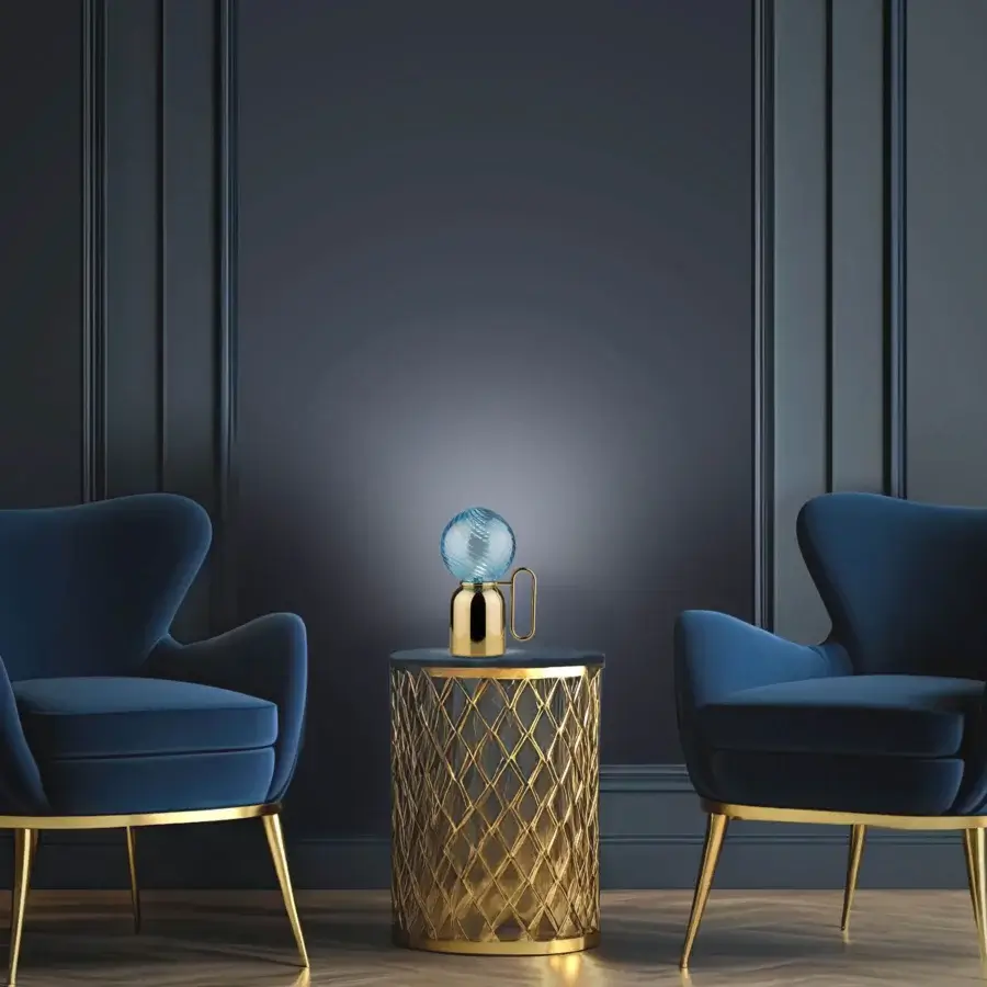 Elegant Euroluce Atlas table lamp in glossy golden metal with swirling textured blue glass shade
