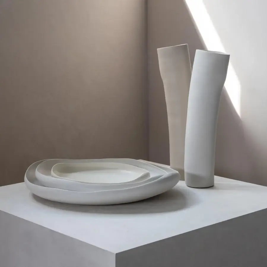 Exclusive Rina Menardi Wind vase sculpted decorative piece crafted in pale off-white baked clay with an asymmetrical silhouette