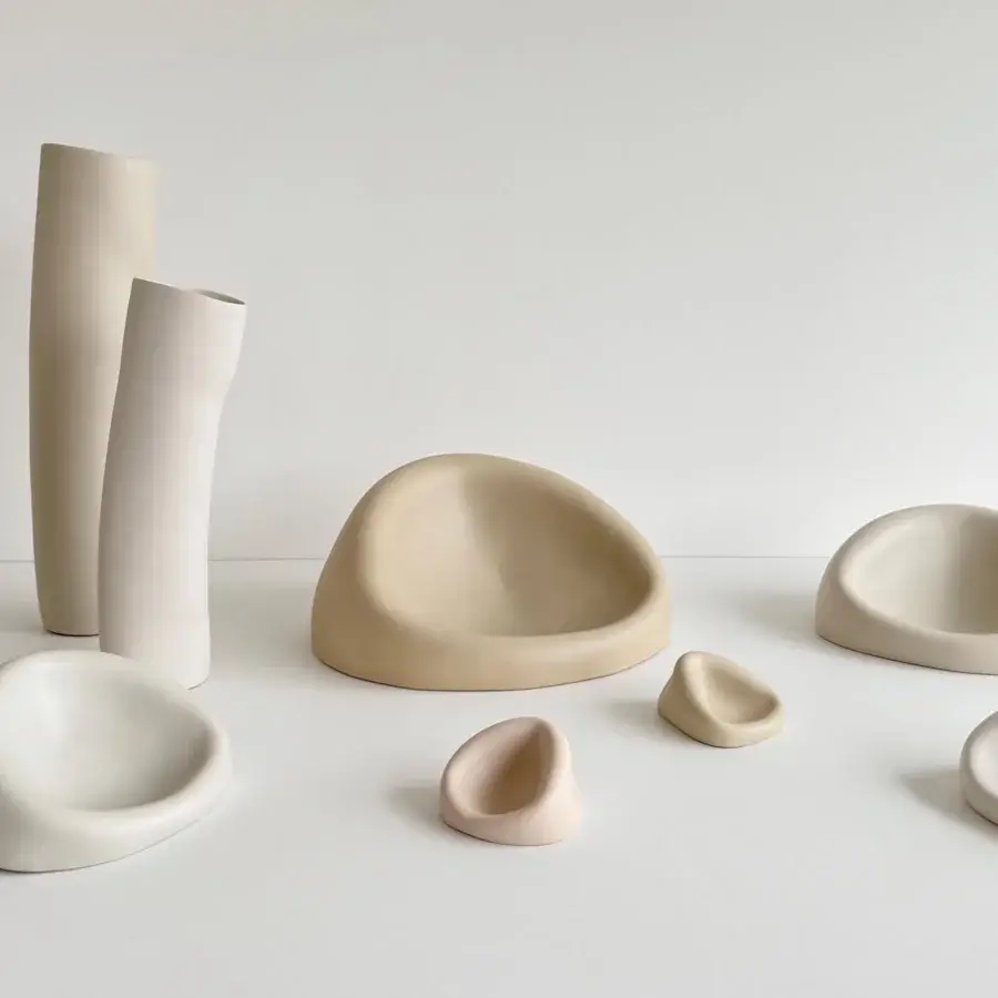 Exceptional Rina Menardi Wind vase crafted from baked clay with a matte neutral beige finish and unique curved form