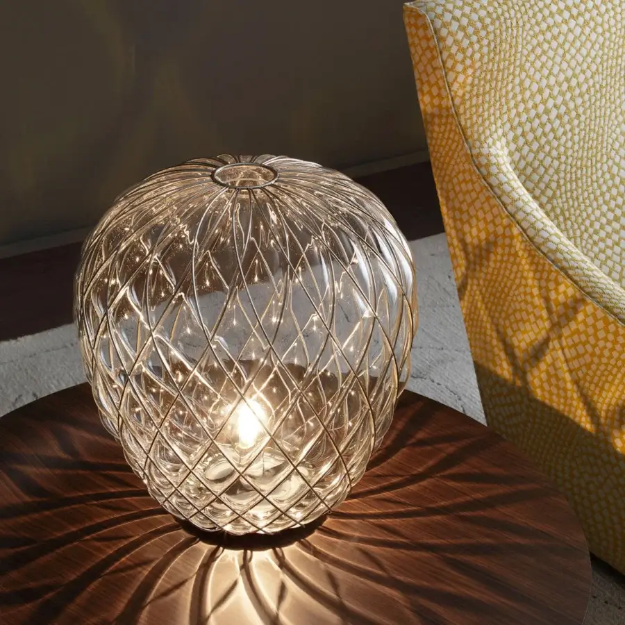 Distinguished FontanaArte Pinecone table lamp crafted with caged blown glass in a glossy, galvanic amber hue with faceted texture