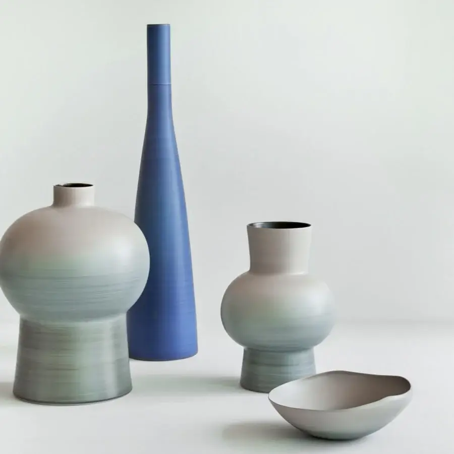Distinguished Rina Menardi Solo vase crafted from baked clay with a captivating gradient of blue shades for decorative use