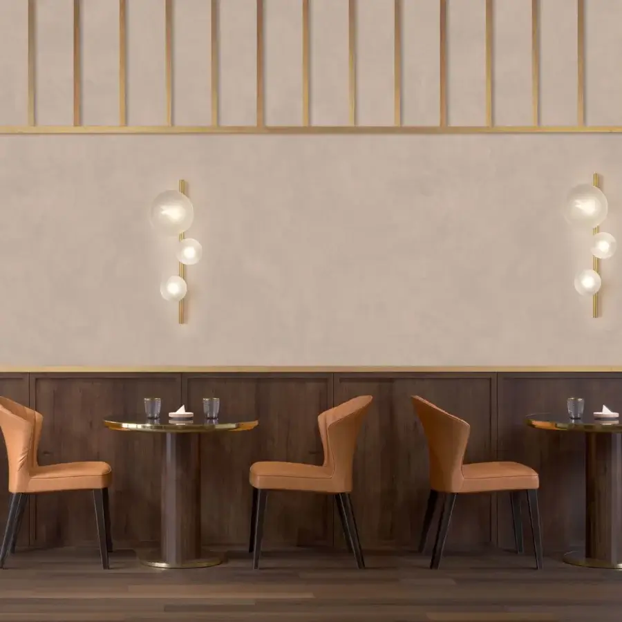 Elegant Euroluce Bubbles wall lamp with translucent glass spheres and a gracefully curved golden metal arm