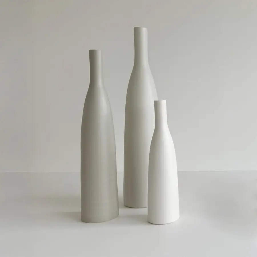 Exceptional Rina Menardi Bottiglie vase crafted in baked clay with a smooth matte surface and light gray off-white tones