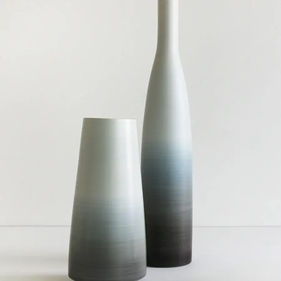 Elegant Rina Menardi Bottiglie vase sculpted from baked clay exhibiting a gradient from pale gray to charcoal with a smooth matte finish