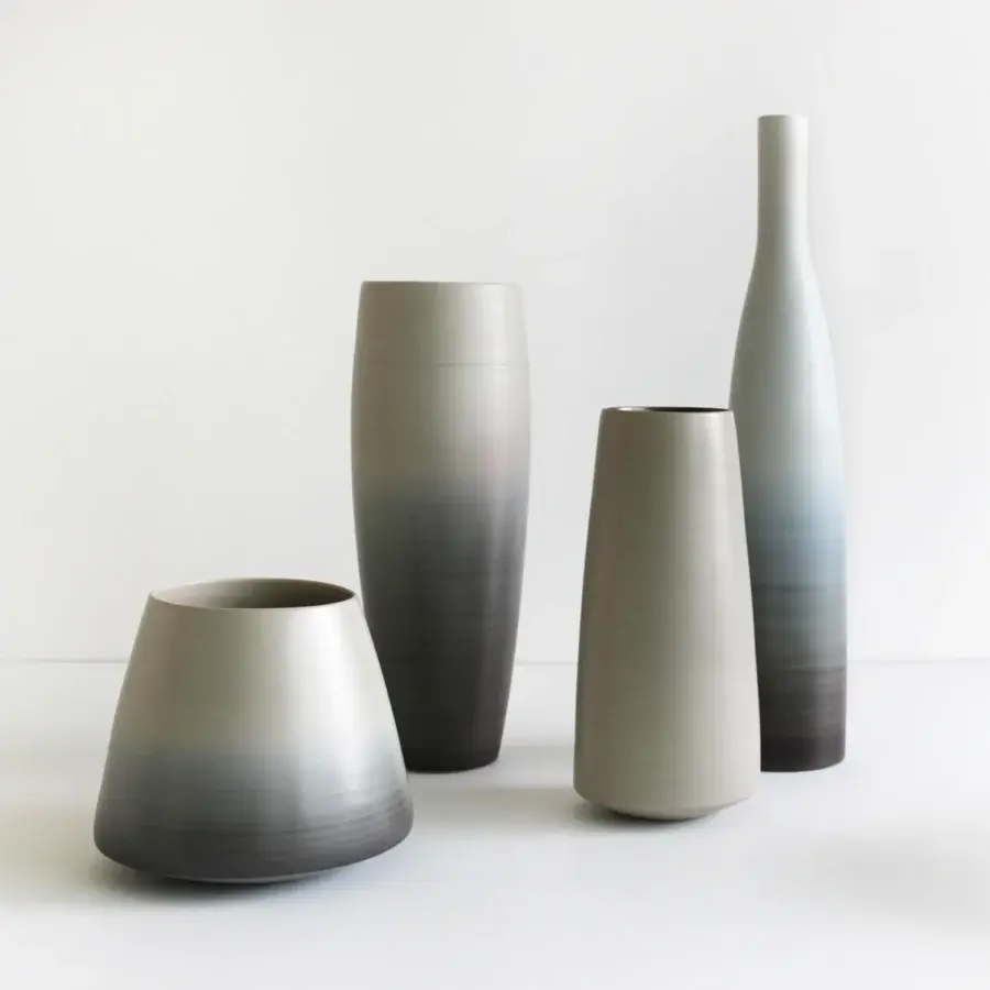 Superior Rina Menardi Bottiglie vase crafted from baked clay exhibiting a grayscale gradient with a smooth matte finish