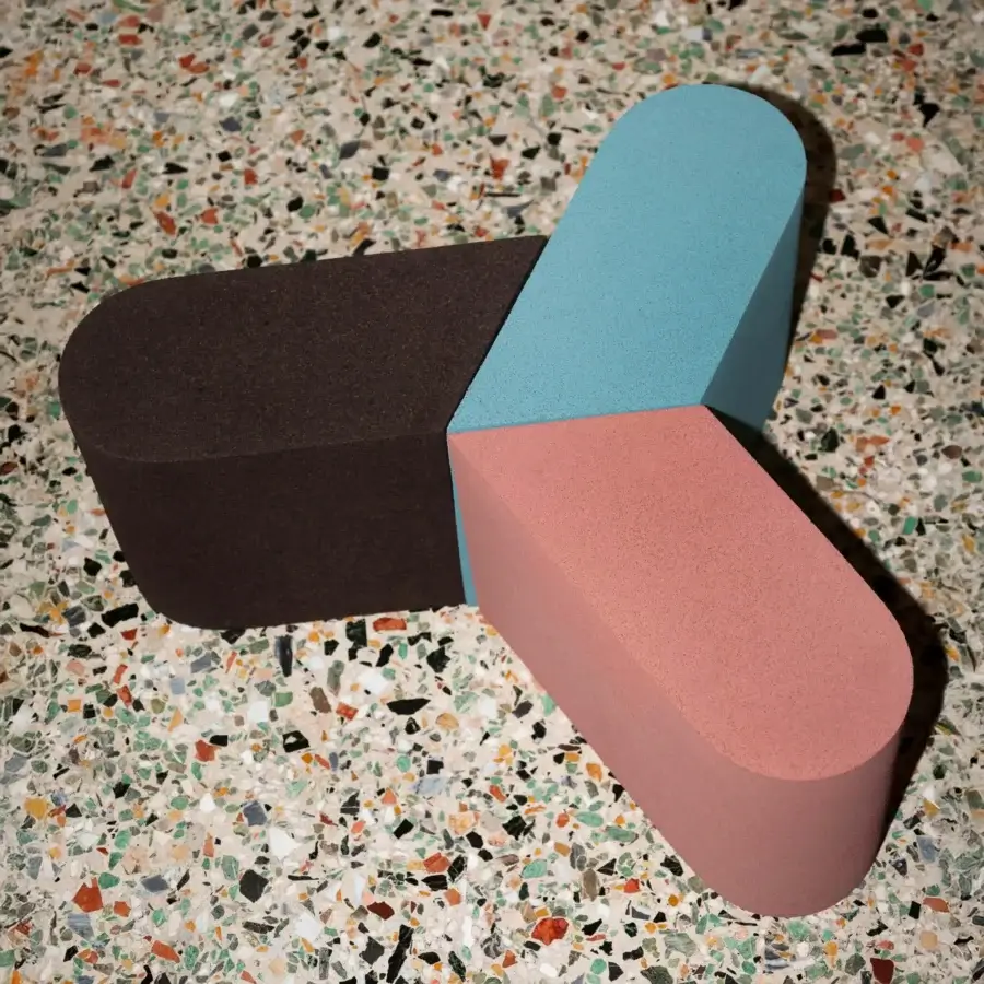 Distinguished Bross Slice Modular Coffee Table with interconnected cork modules in dark brownish-black, teal blue, and dusty rose pink with a matte finish