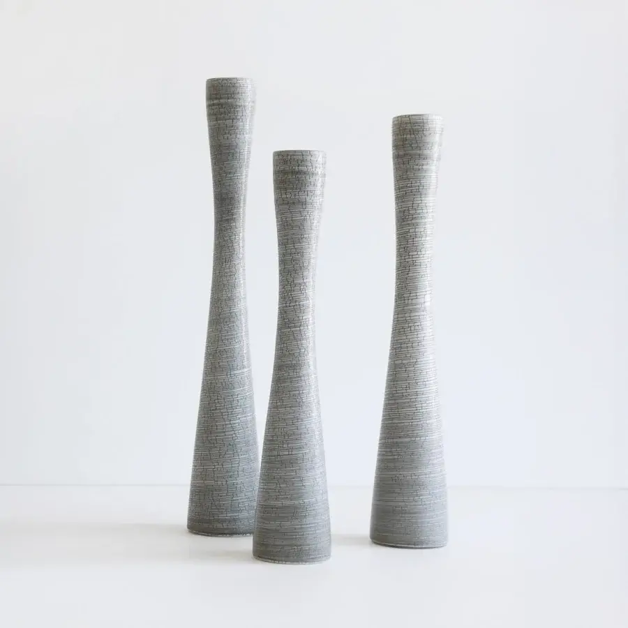 Exclusive Rina Menardi Flauti vase, a handcrafted piece in muted gray baked clay with textured vertical striations