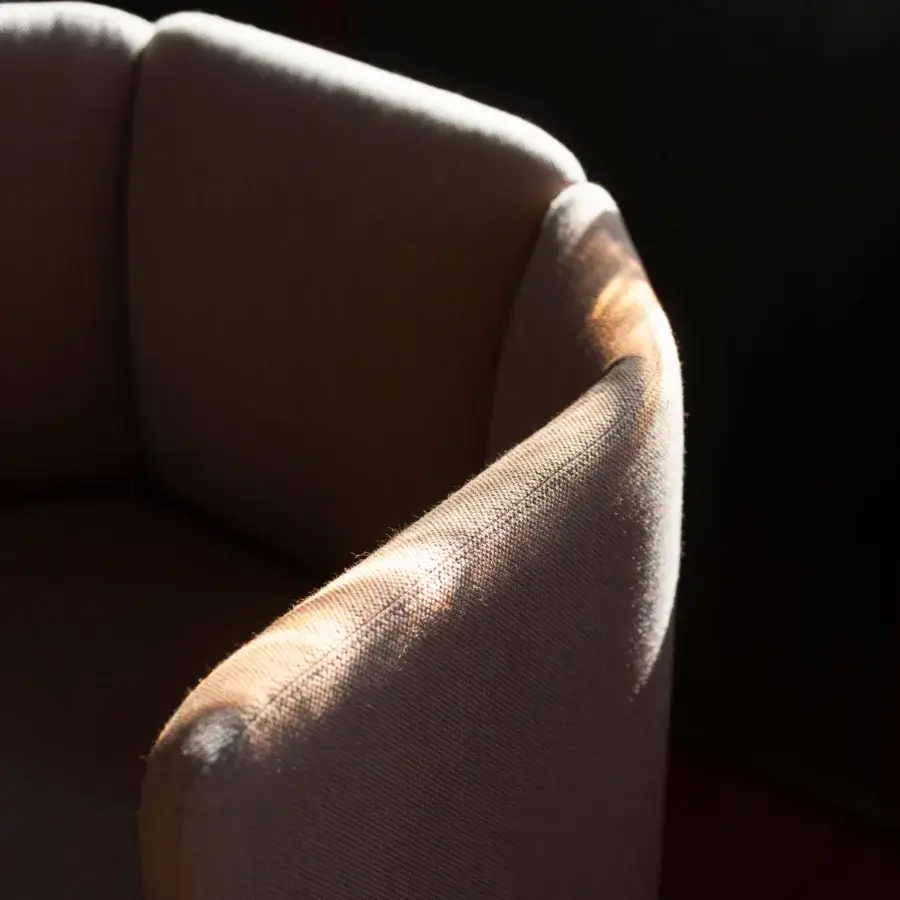 Distinguished Bross Velia lounge chair with sculpted form upholstered in textured woven fabric and matte finish