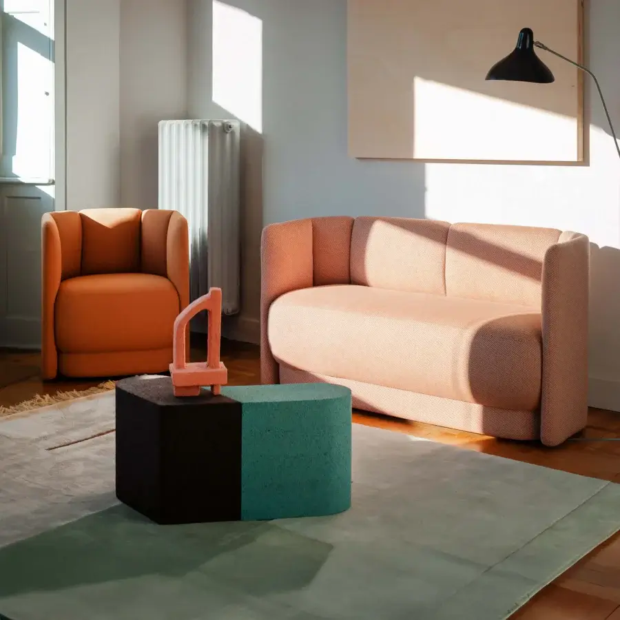 Distinguished Bross Velia sofa with compact form and refined details upholstered in muted coral textile with elegant vertical seams