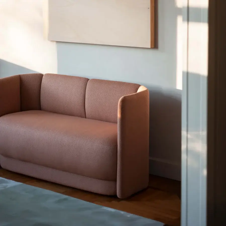 Superior Bross Velia sofa with organically curved form and beautifully textured fabric in a muted terracotta tone crafted in Italy