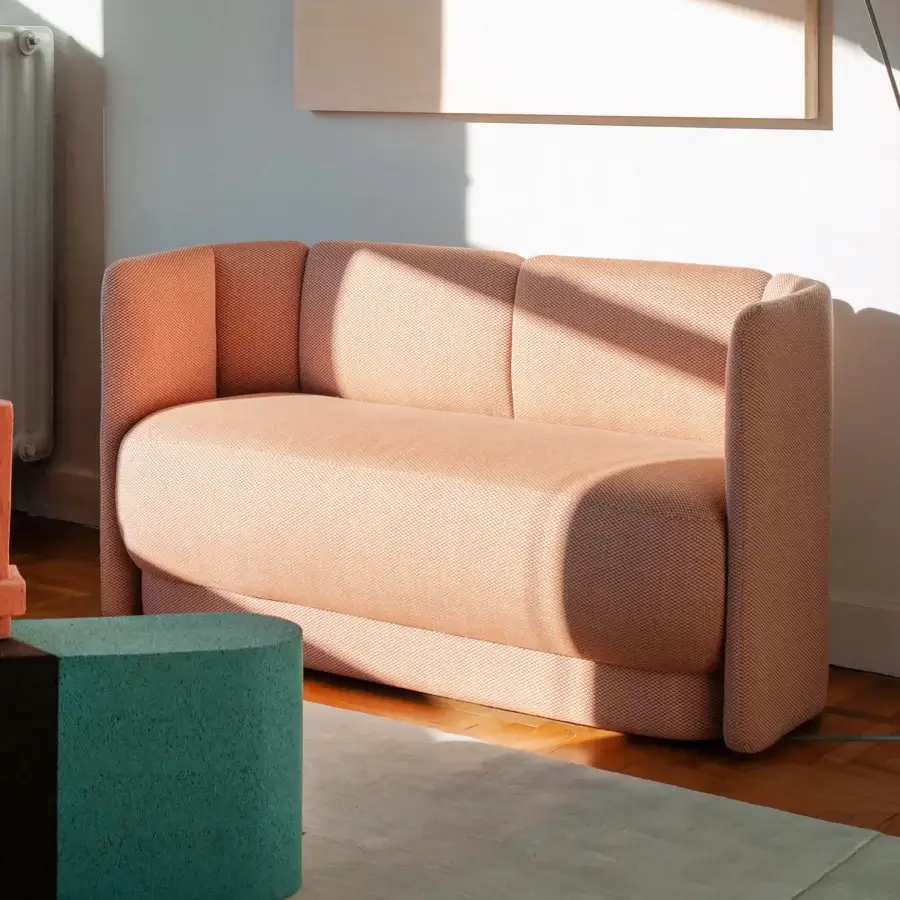 Elegant Bross Velia sofa with compact organically curved form and textured coral upholstery crafted in Italy