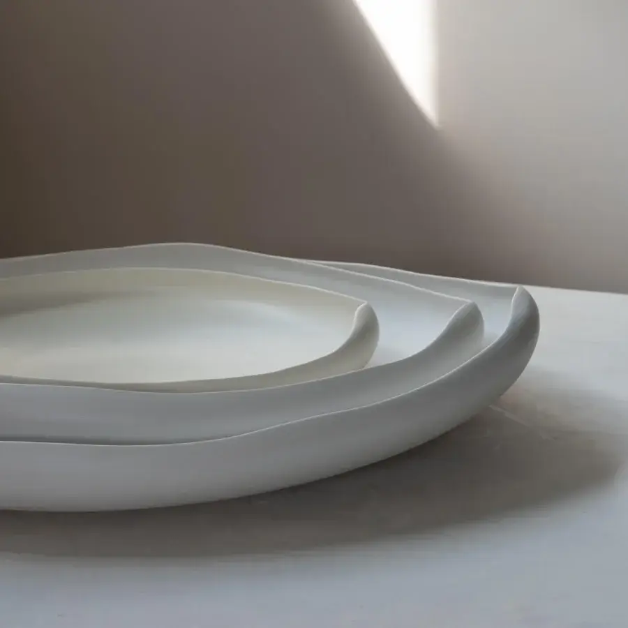 Elegant Rina Menardi Laguna centerpiece crafted in baked clay with gently curving nested vessels and a smooth matte surface