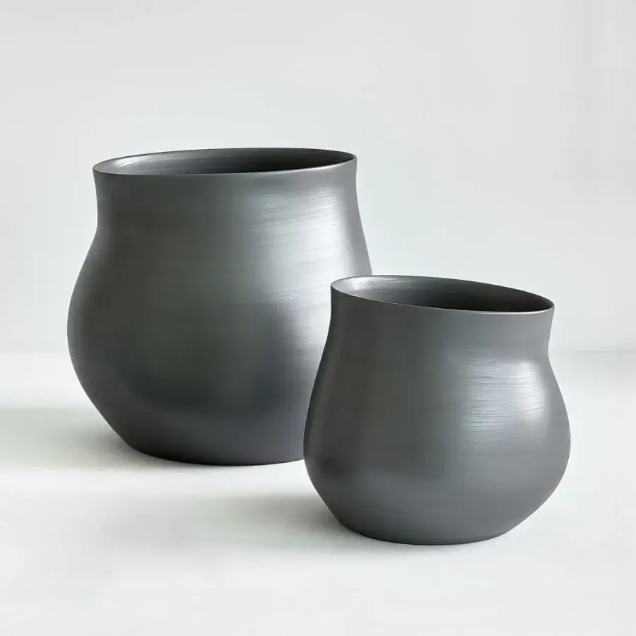 Exceptional Rina Menardi Agape vessel sculpted from baked clay in dark gray with a smooth matte finish